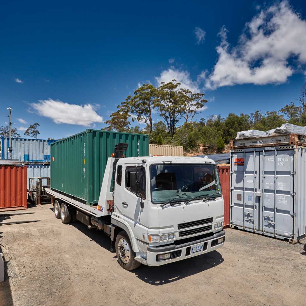 A shipping container loaded onto a truck